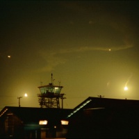 Control_tower_at_night_with_flares