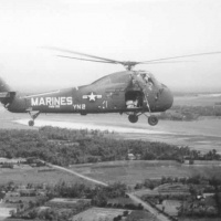 A/C on resupply mission. Note bags of rice in door way