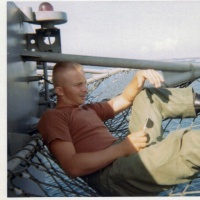 Dave Sharpe riding the bow of the USS Guam