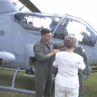 LtCol Holder presents Nancy with the flight suit.