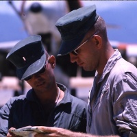 VMA 225 Pilots (L) Lt. Harry Slacum and Lt. Ron Kleiboeker check mission map at Chu Lai Aug. 1965