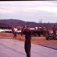 VMA 225 Marine Plane Captain Guides A4C Aircraft out of Revetment at Chu Lai Aug. 1965.