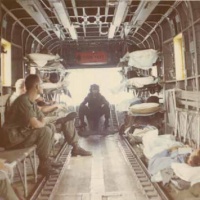 In flight with 9 of 24 litter positions filled; a C-130 waits in Da Nang.