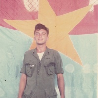 J.B. BECKER W CAPTURED NVA FLAG
